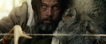 Movie still from “Wildling” (2018), directed by Fritz Böhm – A person with long hair and a beard; Close Up shot, Over the shoulder angle
