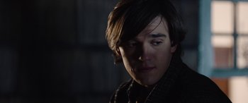 Movie still from “Wildling” (2018), directed by Fritz Böhm – A person wearing a jacket; Close Up shot, Over the shoulder angle