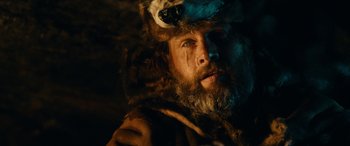 Movie still from “Wildling” (2018), directed by Fritz Böhm – A man with a beard wearing a bear costume; Close Up shot, Low angle