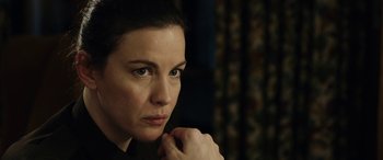 Movie still from “Wildling” (2018), directed by Fritz Böhm – A person holding their hand to her chin; Close Up shot, Over the shoulder angle