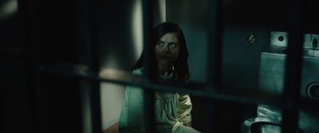 Movie still from “Wildling” (2018), directed by Fritz Böhm – A woman sitting behind bars in a jail cell; Close Up shot, Over the shoulder angle