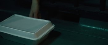 Movie still from “Wildling” (2018), directed by Fritz Böhm – A white styrofoam container sitting on top of a table; Extreme Close Up shot, High angle
