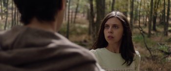 Movie still from “Wildling” (2018), directed by Fritz Böhm – A young woman and a young man in the woods; Close Up shot, Over the shoulder angle