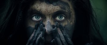 Movie still from “Wildling” (2018), directed by Fritz Böhm – A person with their face covered in dirt; Extreme Close Up shot, Overhead angle