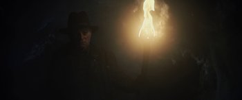 Movie still from “Wildling” (2018), directed by Fritz Böhm – A man in a hat holding a burning candle; Medium shot, Low angle