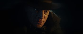 Movie still from “Wildling” (2018), directed by Fritz Böhm – A person wearing a hat; Close Up shot, Over the shoulder angle