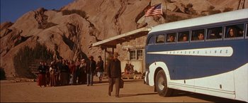 Movie still from “Windtalkers” (2002), directed by John Woo – An old blue van parked in front of a group of people; Wide shot, Low angle