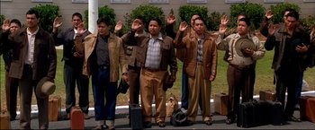 Movie still from “Windtalkers” (2002), directed by John Woo – A group of men standing next to each other on the side of the road; Wide shot, High angle