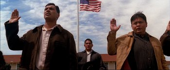 Movie still from “Windtalkers” (2002), directed by John Woo – A group of men standing next to each other under an american flag; Medium shot, Low angle