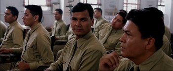 Movie still from “Windtalkers” (2002), directed by John Woo – A group of men sitting in a room together; Close Up shot, Over the shoulder angle