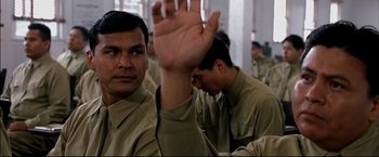 Movie still from “Windtalkers” (2002), directed by John Woo – A group of men in tan shirts holding their hands up in the air; Close Up shot, Low angle