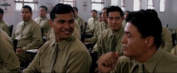 Movie still from “Windtalkers” (2002), directed by John Woo – A group of men sitting in a room together; Medium shot, Over the shoulder angle
