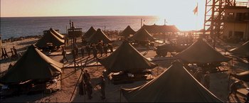 Movie still from “Windtalkers” (2002), directed by John Woo – A group of tents on the beach near the ocean; Extreme Wide shot, High angle