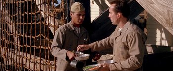 Movie still from “Windtalkers” (2002), directed by John Woo – Two men are serving food to each other; Medium shot, Over the shoulder angle