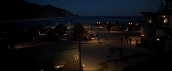 Movie still from “Windtalkers” (2002), directed by John Woo – A group of people walking on the beach at night; Extreme Wide shot, High angle