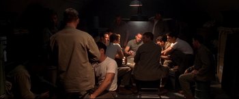 Movie still from “Windtalkers” (2002), directed by John Woo – A group of people sitting around a table; Medium shot, High angle