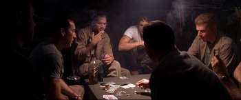 Movie still from “Windtalkers” (2002), directed by John Woo – A group of men sitting at a table playing cards; Medium shot, High angle