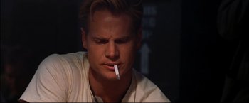 Movie still from “Windtalkers” (2002), directed by John Woo – A person with a cigarette in his mouth; Close Up shot, Over the shoulder angle