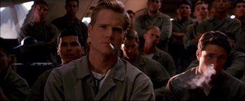 Movie still from “Windtalkers” (2002), directed by John Woo – A man smoking a cigarette in front of a group of men; Close Up shot, Low angle