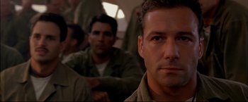 Movie still from “Windtalkers” (2002), directed by John Woo – A man's face as he sits on a bus; Close Up shot, Low angle