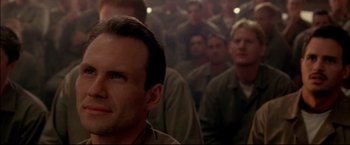 Movie still from “Windtalkers” (2002), directed by John Woo – A group of men standing next to each other in a room; Close Up shot, Over the shoulder angle