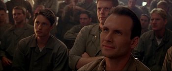 Movie still from “Windtalkers” (2002), directed by John Woo – A group of men sitting next to each other in a room; Close Up shot, Over the shoulder angle