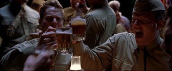 Movie still from “Windtalkers” (2002), directed by John Woo – A group of men drinking beer at a party; Medium shot, Low angle