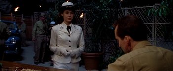 Movie still from “Windtalkers” (2002), directed by John Woo – A woman dressed in a sailor's uniform standing in front of a man; Medium shot, Over the shoulder angle