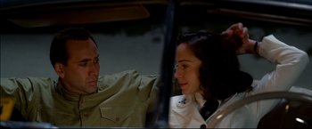 Movie still from “Windtalkers” (2002), directed by John Woo – A man and a woman sitting next to each other in a car; Close Up shot, Over the shoulder angle