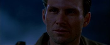 Movie still from “Windtalkers” (2002), directed by John Woo – A man's face in the dark; Close Up shot, Low angle