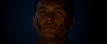 Movie still from “Windtalkers” (2002), directed by John Woo – A person's face in the dark; Close Up shot, Low angle