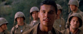 Movie still from “Windtalkers” (2002), directed by John Woo – A young man in military fatigues and a helmet; Close Up shot, Low angle