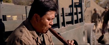 Movie still from “Windtalkers” (2002), directed by John Woo – A man holding a long wooden stick in his mouth; Close Up shot, Low angle