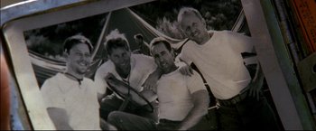 Movie still from “Windtalkers” (2002), directed by John Woo – A group of men sitting next to each other under an awning; Extreme Close Up shot, High angle