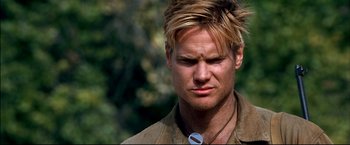 Movie still from “Windtalkers” (2002), directed by John Woo – A person wearing a necklace; Close Up shot, Over the shoulder angle