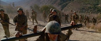 Movie still from “Windtalkers” (2002), directed by John Woo – A group of men in military fatigues marching; Wide shot, High angle