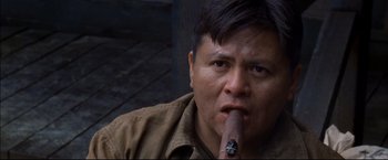 Movie still from “Windtalkers” (2002), directed by John Woo – A person with a cigar; Close Up shot, Low angle