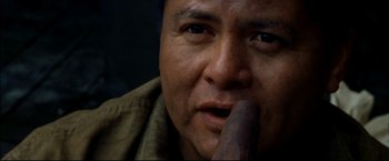 Movie still from “Windtalkers” (2002), directed by John Woo – A man with a large black object in his mouth; Close Up shot, Low angle