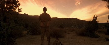 Movie still from “Windtalkers” (2002), directed by John Woo – A man standing in a field at sunset; Wide shot, Low angle