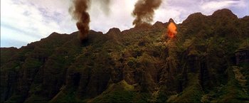Movie still from “Windtalkers” (2002), directed by John Woo – Smoke billows out of a fire on the side of a mountain; Extreme Wide shot, High angle