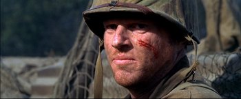 Movie still from “Windtalkers” (2002), directed by John Woo – A person wearing a hat and bandanna; Close Up shot, Low angle