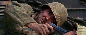 Movie still from “Windtalkers” (2002), directed by John Woo – A man in a military uniform is holding a gun; Close Up shot, High angle