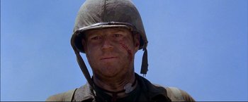 Movie still from “Windtalkers” (2002), directed by John Woo – A man with a helmet on and bandage on his face; Close Up shot, Low angle
