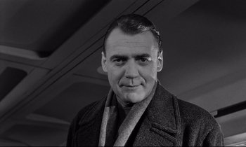 Movie still from “Wings of Desire” (1987), directed by Wim Wenders – An older man wearing a suit and tie; Close Up shot, Low angle