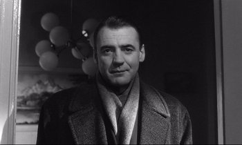 Movie still from “Wings of Desire” (1987), directed by Wim Wenders – An old photo of a man in a coat; Close Up shot, Low angle