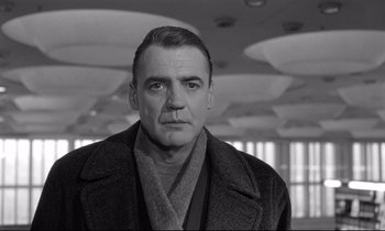 Movie still from “Wings of Desire” (1987), directed by Wim Wenders – An older man wearing a coat and a scarf; Close Up shot, Low angle