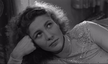 Movie still from “Wings of Desire” (1987), directed by Wim Wenders – Black and white photograph of a young woman looking at the camera; Close Up shot, High angle