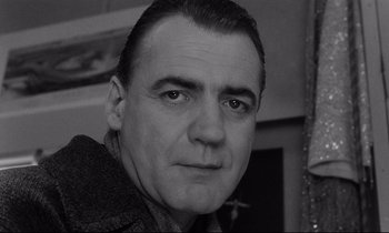 Movie still from “Wings of Desire” (1987), directed by Wim Wenders – Black and white photograph of a man's face; Close Up shot, Low angle