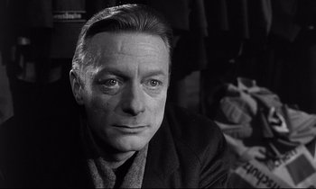 Movie still from “Wings of Desire” (1987), directed by Wim Wenders – Black and white photograph of a man in a suit; Close Up shot, Low angle