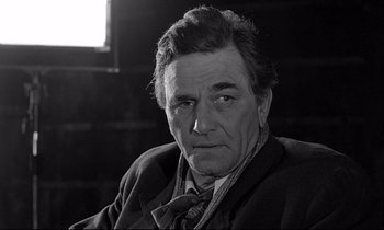 Movie still from “Wings of Desire” (1987), directed by Wim Wenders – Black and white photograph of a man in a suit and tie; Close Up shot, Low angle